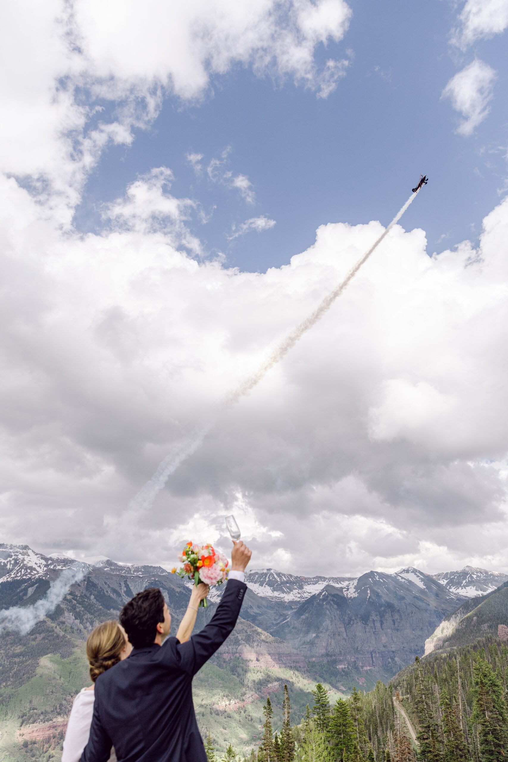Couple watching small airplane fly off over Telluride